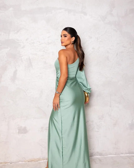 Back view of sage green satin maxi dress with one shoulder and flowing skirt