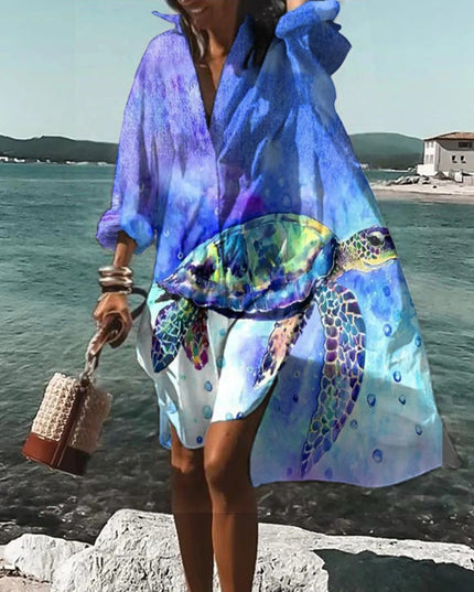 Blue beach mini shirt dress with abstract ocean print, long sleeves, and breezy button front