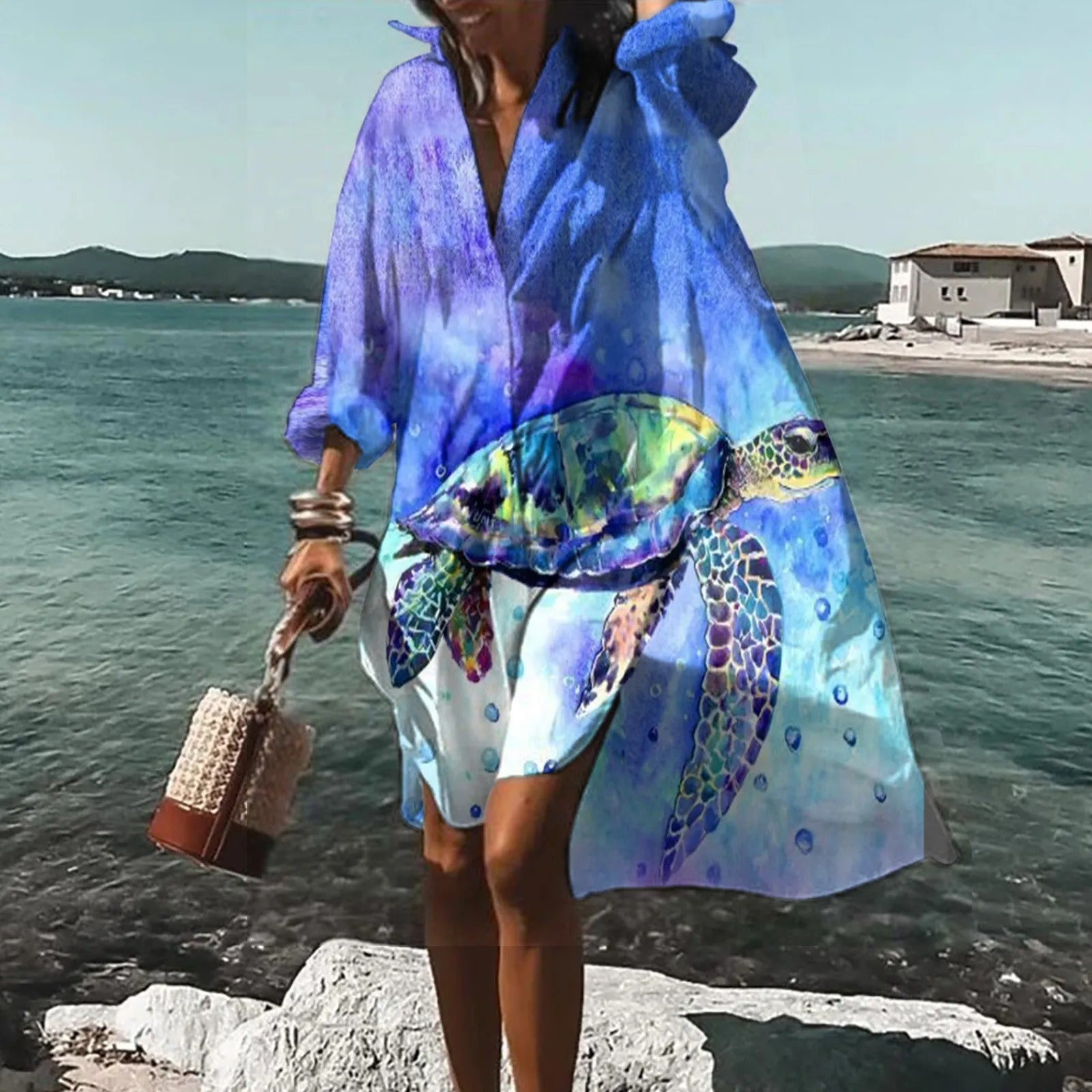 Blue beach mini shirt dress with abstract ocean print, long sleeves, and breezy button front