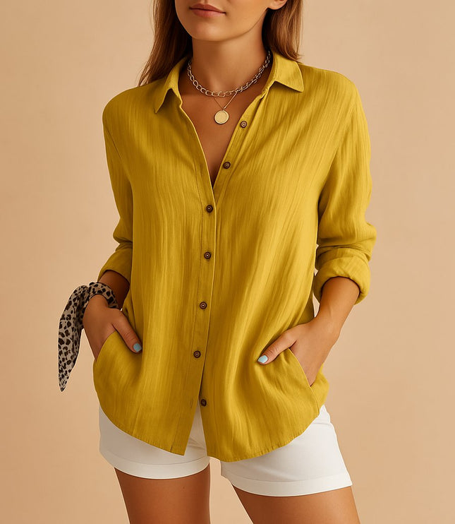 Mustard yellow linen button down shirt styled with rolled sleeves and white shorts