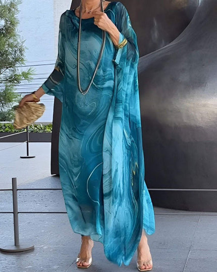 Teal abstract print maxi dress with sheer sleeves and flowing vacation style