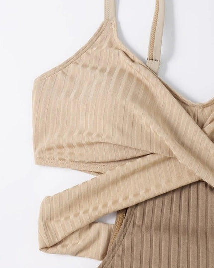 Close up of beige ribbed swimsuit showing crisscross cut out top and textured fabric detail