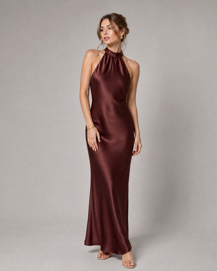Side angle of burgundy cocktail satin halter midi dress showing smooth drape and fit