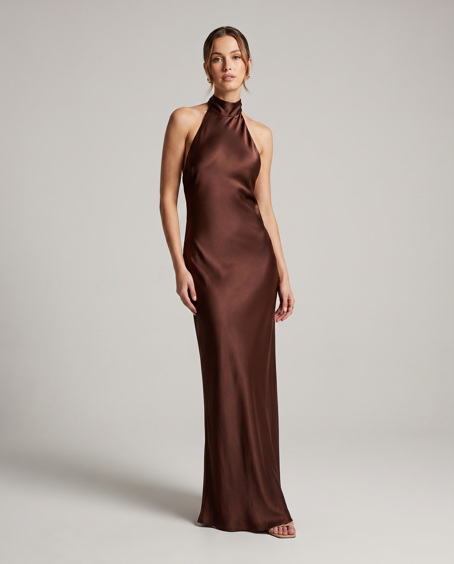 Front view of brown satin halter midi dress with high neckline and elegant body-skimming shape