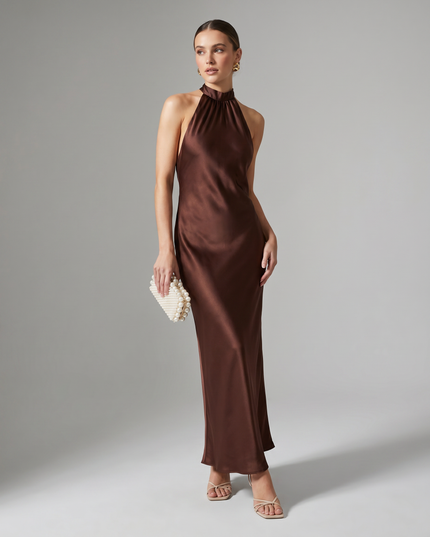 Full length burgundy satin halter midi dress styled with pearl clutch and strappy heels