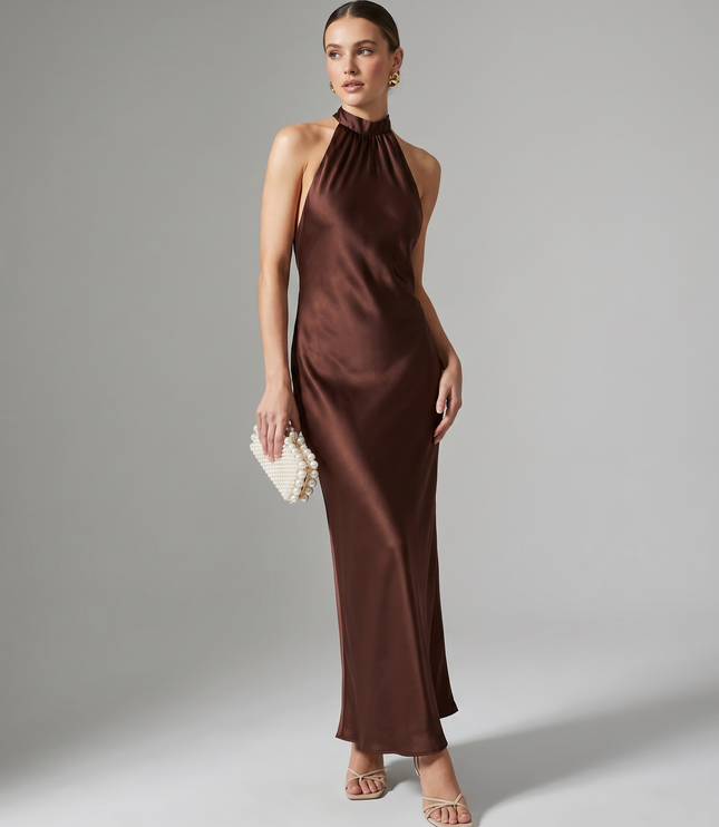 Full length burgundy satin halter midi dress styled with pearl clutch and strappy heels