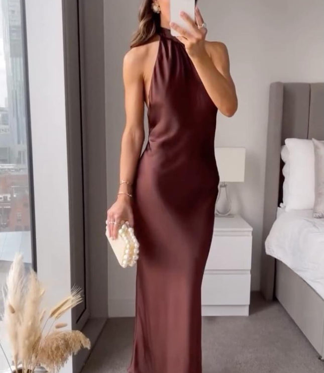 Mirror selfie view of burgundy satin halter midi dress with sleeveless cut and midi length