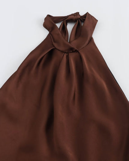 Flat lay of brown satin halter midi dress showing tied halter neckline and flowing skirt