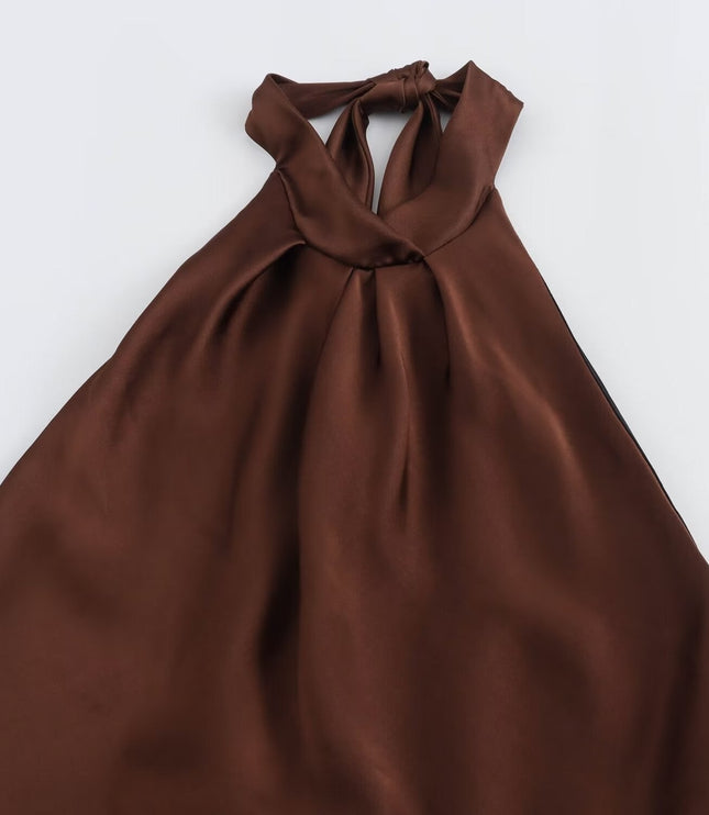Flat lay of brown satin halter midi dress showing tied halter neckline and flowing skirt
