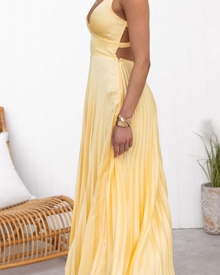 Side view of pleated yellow summer dress with V neck and open back detail