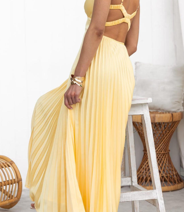 Back view of yellow maxi dress with crisscross strap detail and pleated skirt