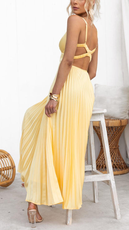 Back view of yellow maxi dress with crisscross strap detail and pleated skirt