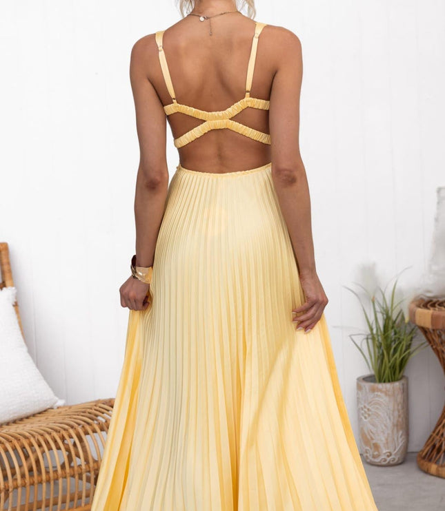 Rear view of pleated V neck maxi dress showing open back and flowing skirt