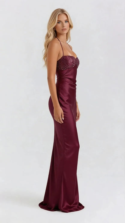 Side view of burgundy satin maxi dress with beaded sweetheart neckline