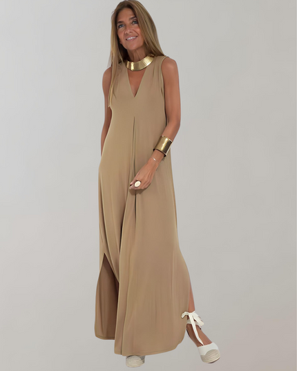 Tan sleeveless maxi dress with deep V-neck, front slit, and gold accessories, summer dress