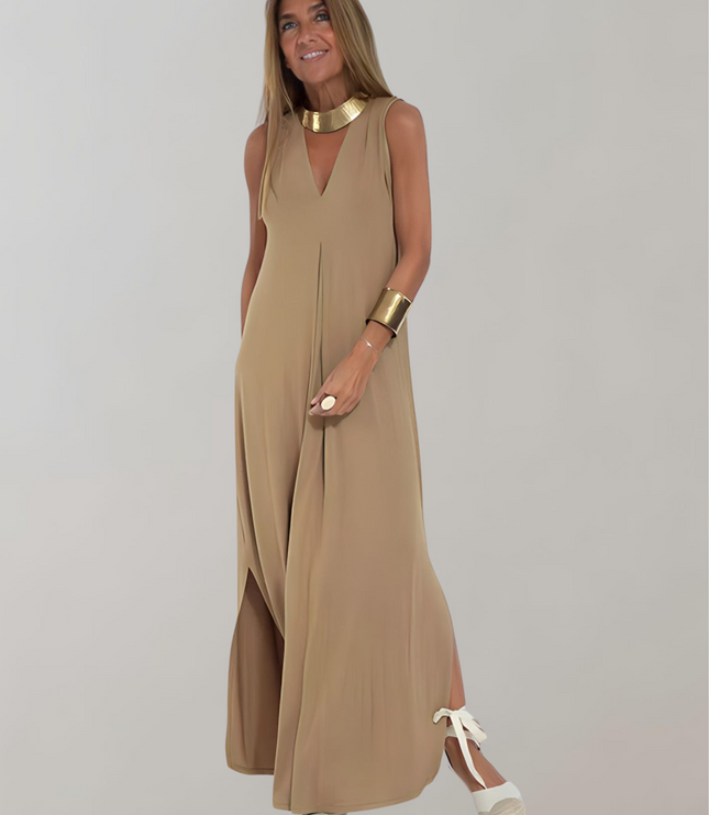 Tan sleeveless maxi dress with deep V-neck, front slit, and gold accessories, summer dress