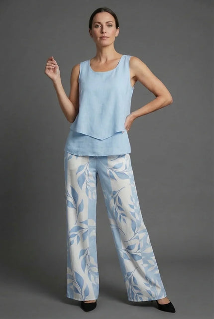 Light blue sleeveless crop top with wide leg floral print pants in a summer co ord set