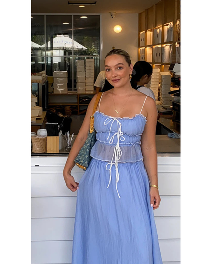 Blue summer maxi skirt set with ruched camisole top and long skirt worn indoors