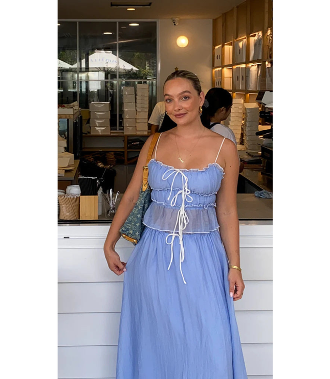 Blue summer maxi skirt set with ruched camisole top and long skirt worn indoors