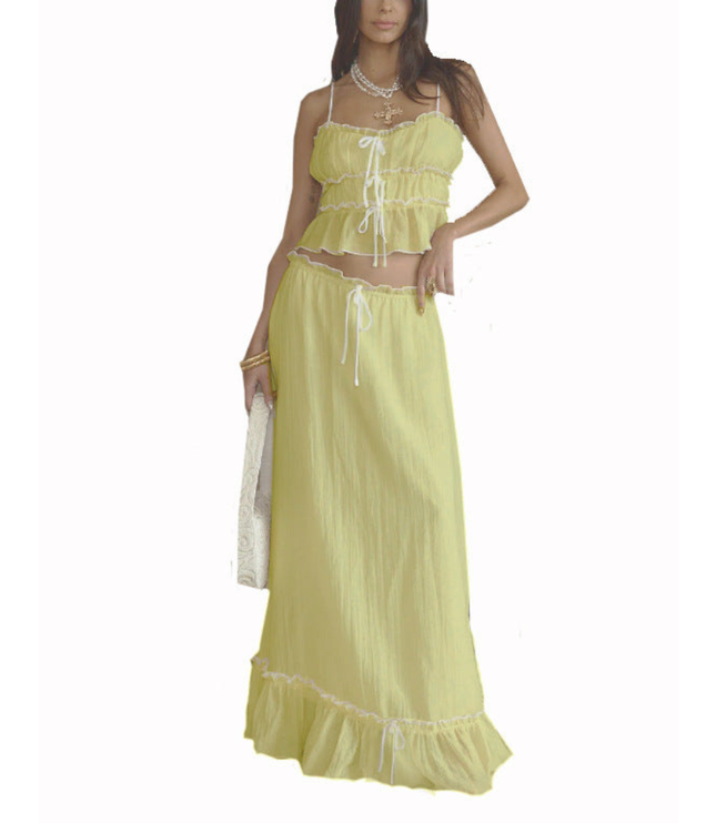Yellow summer maxi skirt set with ruffled crop top and matching long skirt on white background