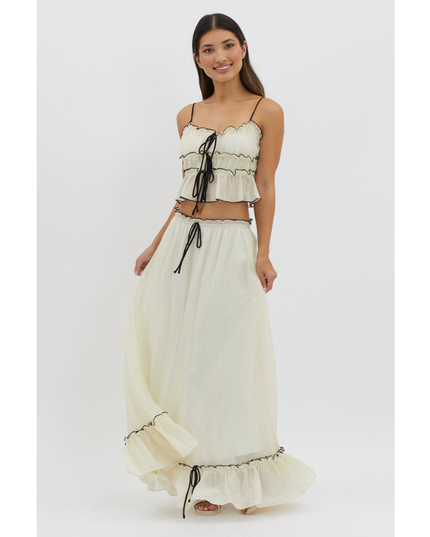 Cream maxi skirt set with black trim and tie-front crop top, front view on white background