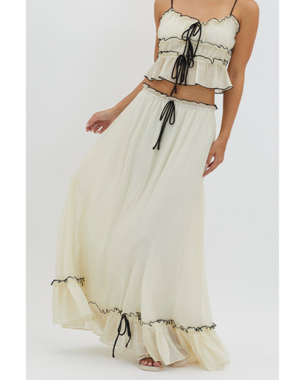 Cream summer maxi skirt set with black trim, close-up of tie-front crop top and flowing skirt