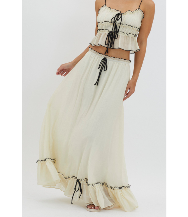 Cream summer maxi skirt set with black trim, close-up of tie-front crop top and flowing skirt