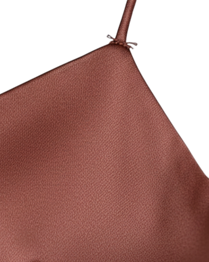 Back view of rust satin slip dress with crisscross spaghetti straps and open back
