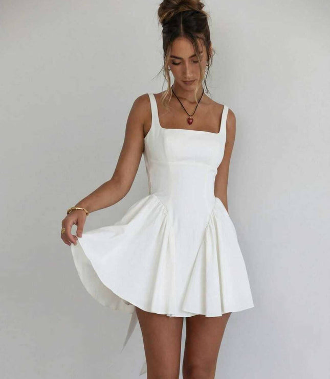 White square neck mini dress with fitted bodice, flared skirt, and open back bow detail