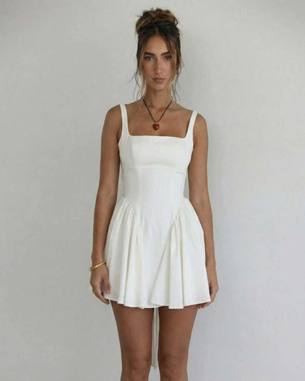 Front view of white wedding guest mini dress with square neckline and gathered skirt