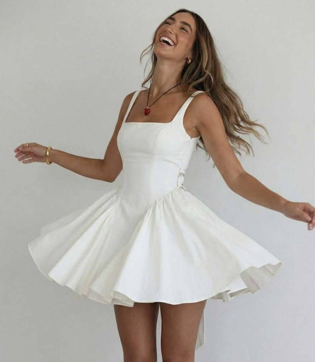 White mini dress with square neck, fitted waist, and soft pleated skirt for summer dress styling