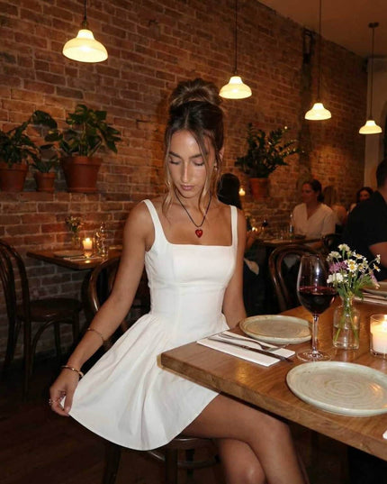 White square neck mini dress styled for dinner, showing flared skirt and fitted bodice