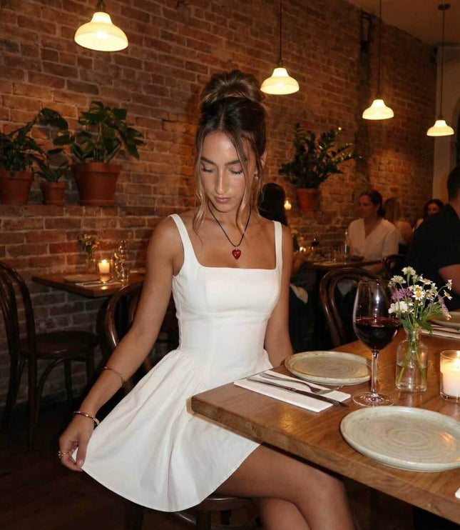 White square neck mini dress styled for dinner, showing flared skirt and fitted bodice