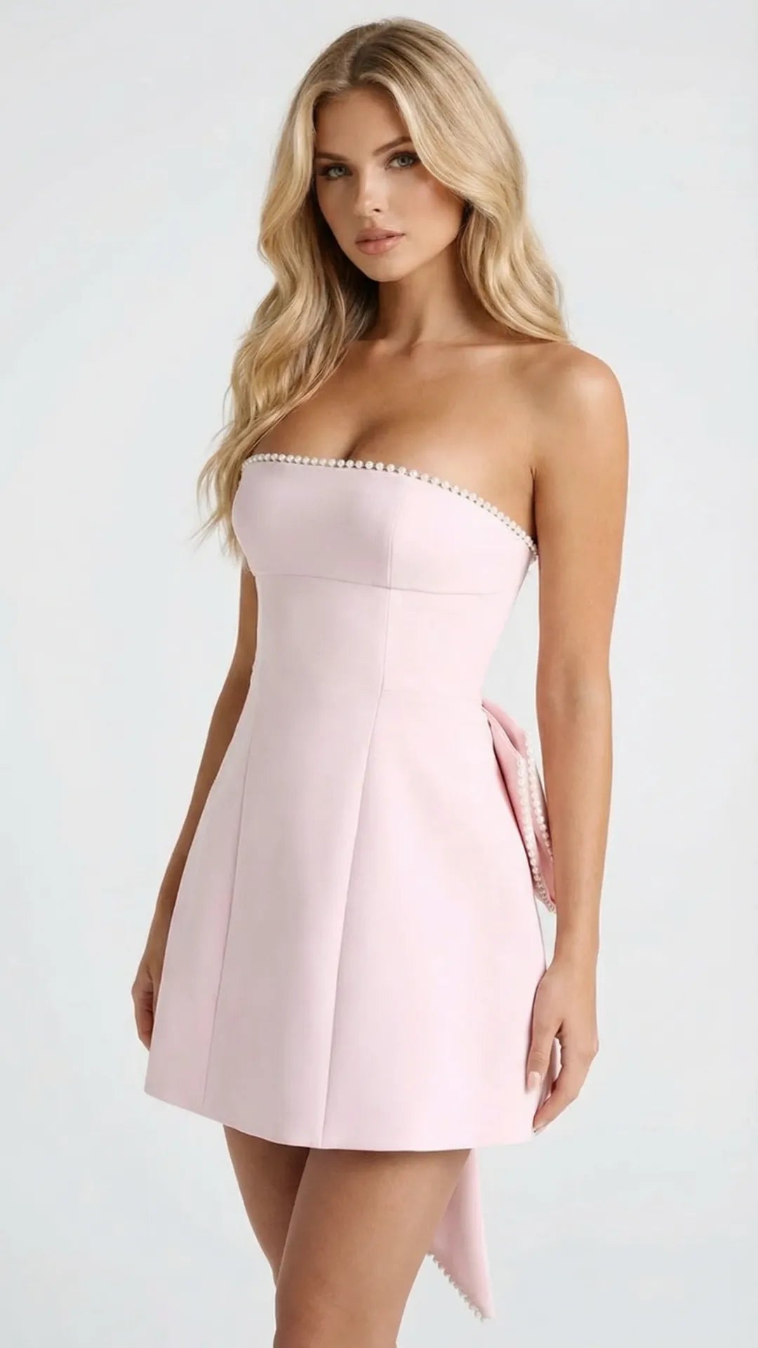 Pink strapless bow mini dress with pearl beaded neckline detail