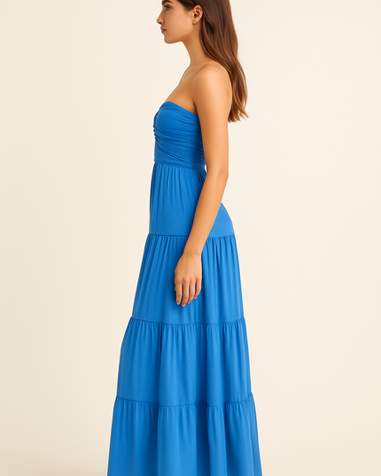 Side view of blue strapless summer dress with fitted waist and flowing maxi length