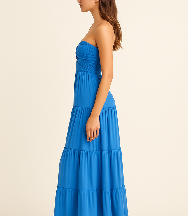 Side view of blue strapless summer dress with fitted waist and flowing maxi length