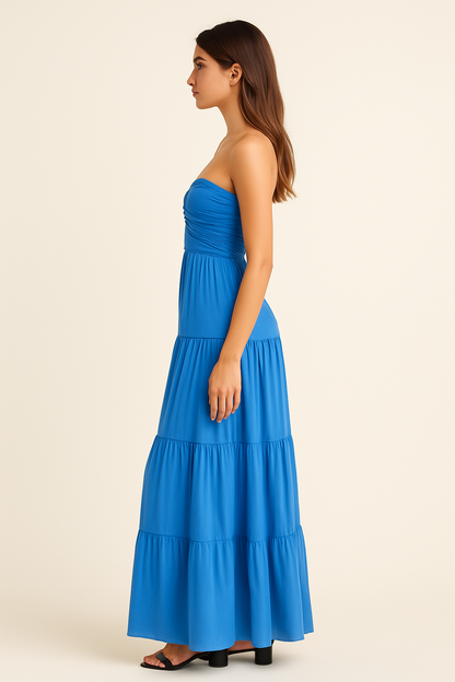 Side view of blue strapless summer dress with fitted waist and flowing maxi length