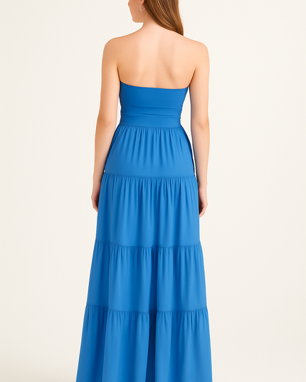 Back view of women's blue strapless maxi dress with smooth bodice and tiered skirt