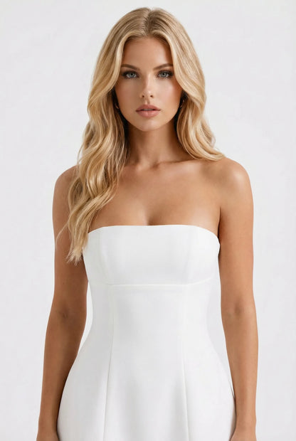 Front view of white strapless mini dress with defined waistline and A-line silhouette