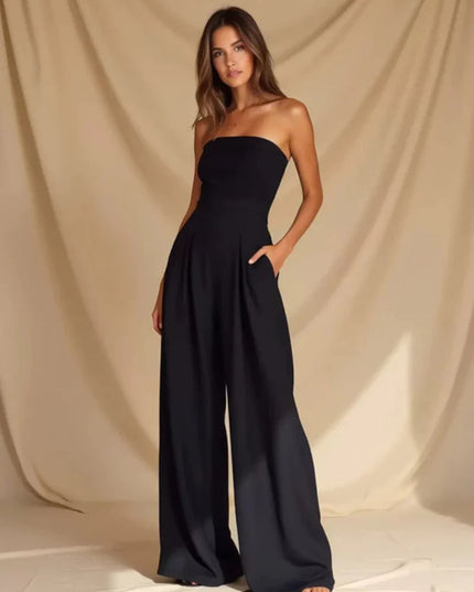 Back view of a navy strapless wide leg jumpsuit with smooth fitted top and flowing pants