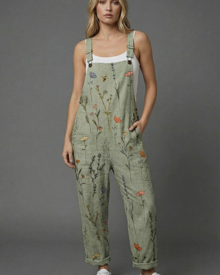 Full-length botanical print wide leg romper in sage green with rolled hems and white sneakers