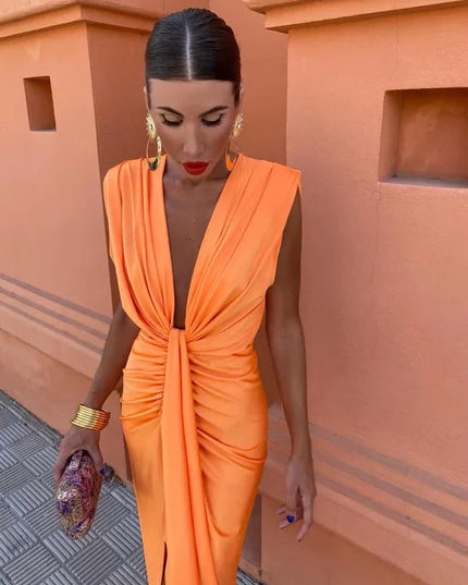 Close-up of orange deep V neck maxi dress with gathered waist and sleeveless cut, summer dress
