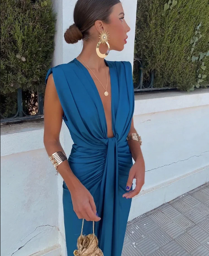 Side view of blue sleeveless maxi dress with deep V neckline, ruched waist and slit