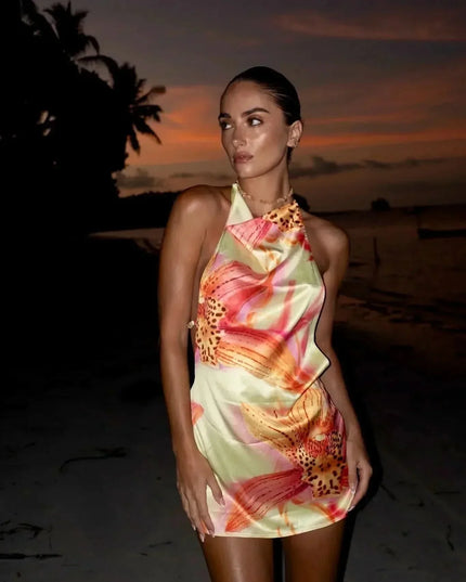Back view of floral halter mini dress with open back and spaghetti straps