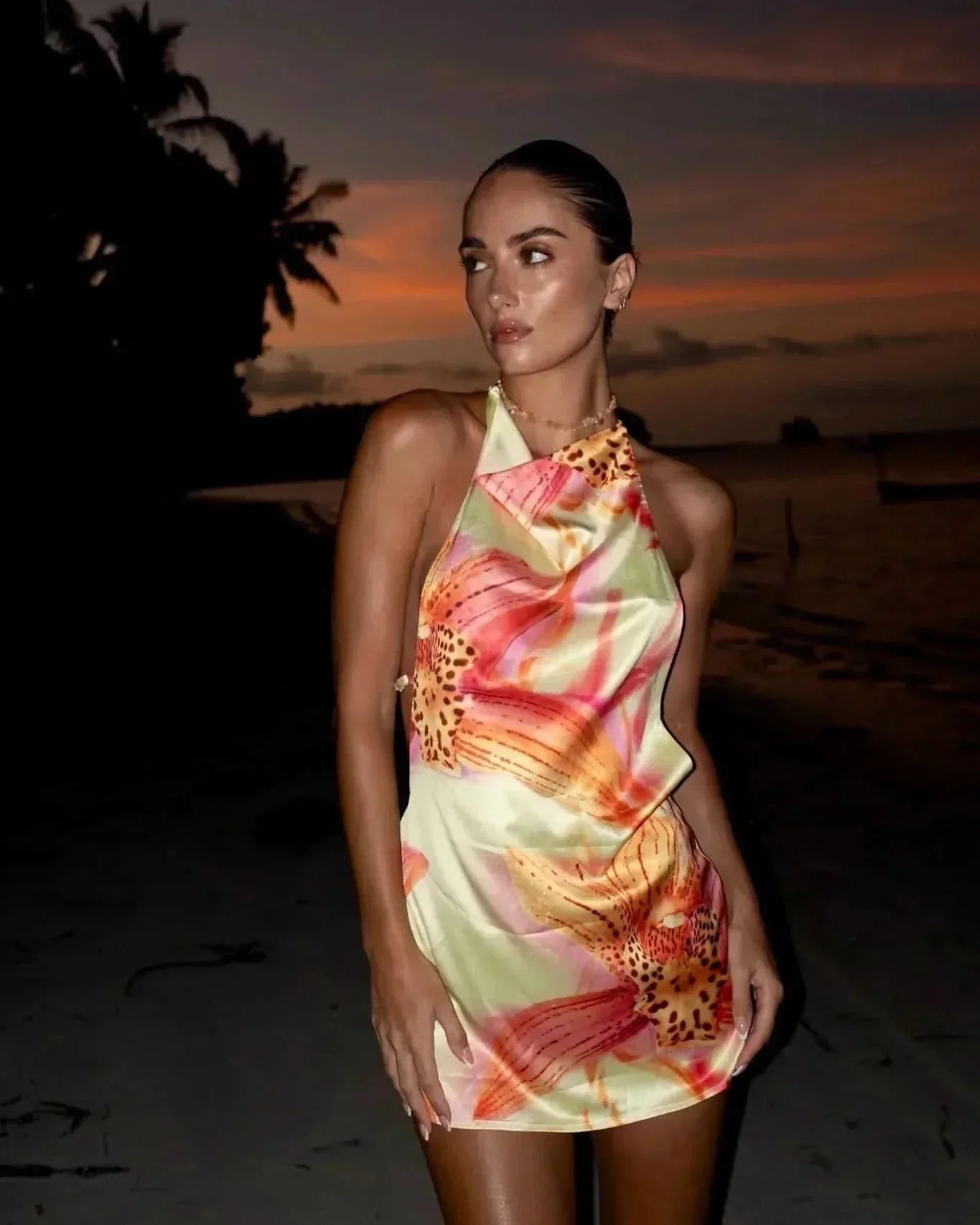 Women’s floral halter mini dress with pastel tropical print and fitted silhouette