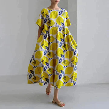 Yellow printed midi dress with leaf and circle pattern, short sleeves, flowy summer dress
