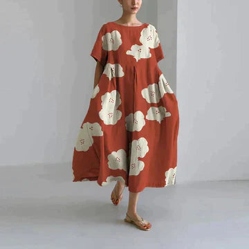 Rust red midi dress with large cream flower print, short sleeves, relaxed summer dress