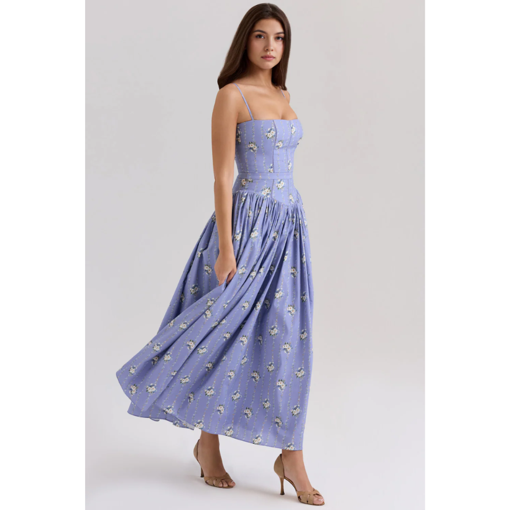 Side view of lavender floral summer dress with fitted waist and flowing midi length