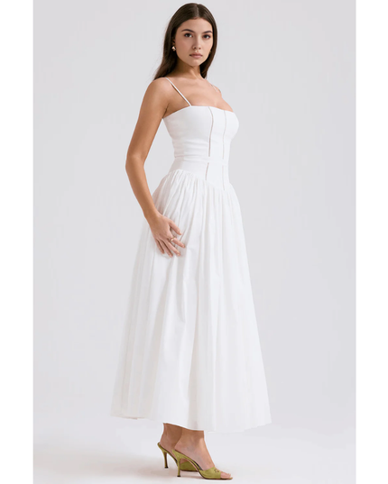 Side view of white summer dress with fitted bodice and soft pleated maxi skirt