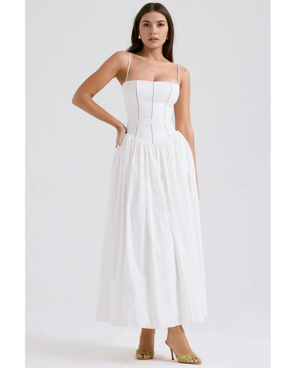 White floral maxi dress with spaghetti straps, fitted bodice, and flowing skirt